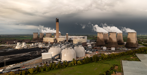 Drax Power Station, Selby, UK - May 5, 2023. Aerial landscape view of Drax Power Station in North Yorkshire with biomass storage tanks for clean energy production and storm clouds