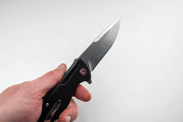 istock closeup hand holding a tanto combat knife isolated on white 1488408094