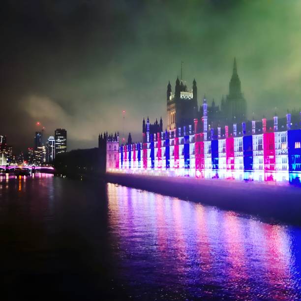 London, UK - April 29, 2023: Lights in London announcing coronation of the King Charles III on the 6th of May on Houses of Parliament and Big Ben stock photo