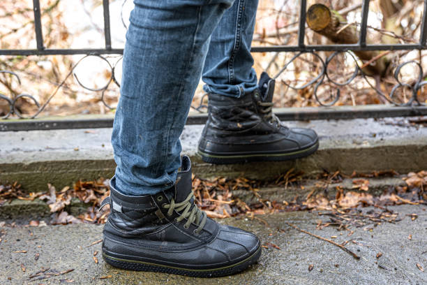 istock A man in boots in bad weather, close-up. 1488409812