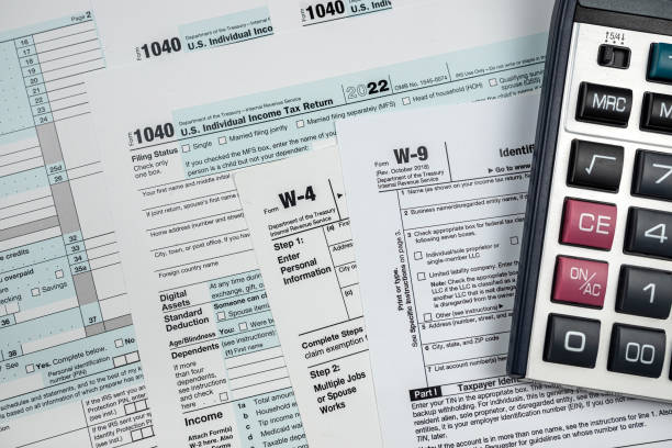 istock empty blank us 1040 tax return form with pen and calculator, deadline 1488409820