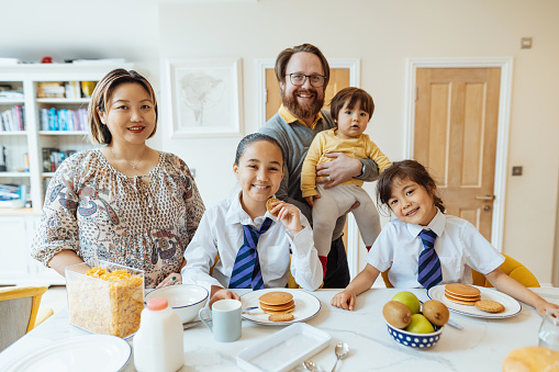 Series of images of real multi generation British Asian mixed family with three kids at home