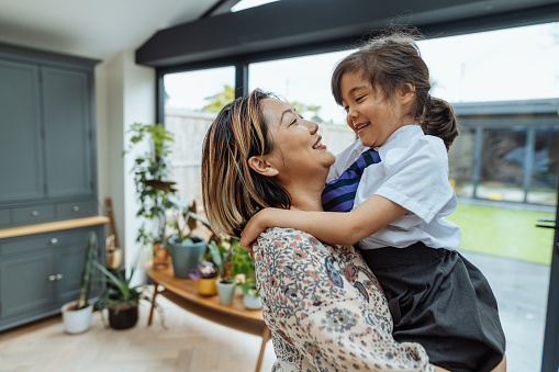 Series of images of real multi generation British Asian mixed family with three kids at home