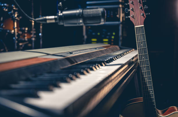 istock Musical keys, guitar and microphone on a dark background. 1488412442