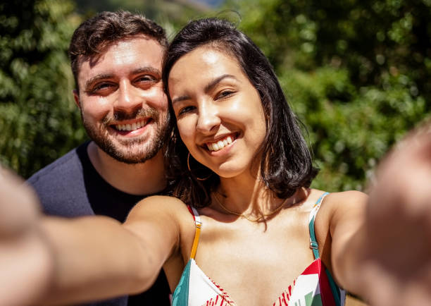 istock Beautiful young couple taking selfies standing outside 1488412490