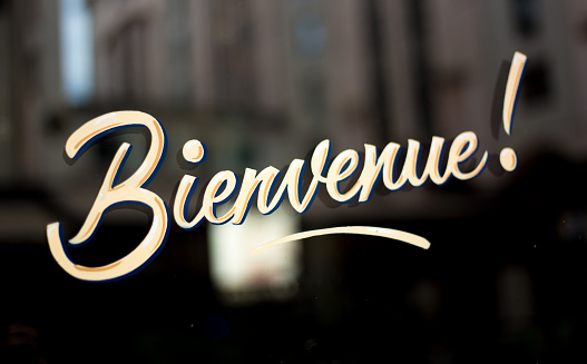 Sign on Shop Window/Door Reading: Bienvenue! Shot in Lyon, France