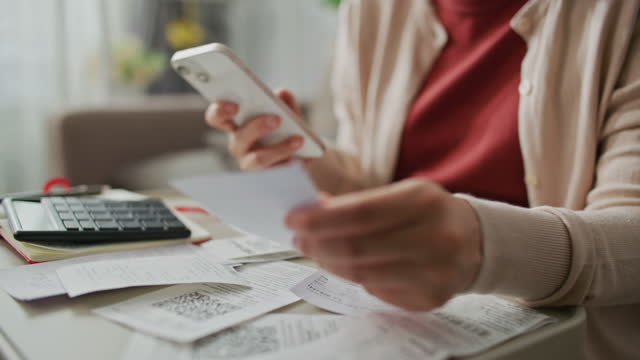 Woman reviewing receipts for Home budget planning