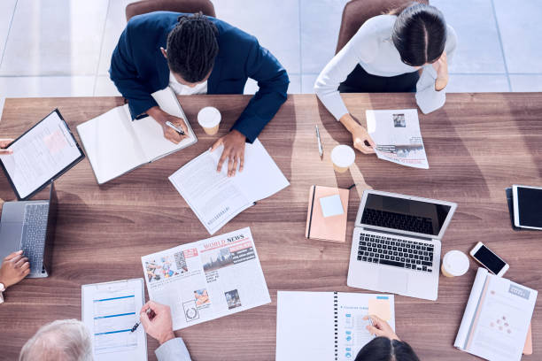 istock Meeting, top view or business people planning a team or group project documents on office desk or table. Collaboration, corporate or focused employees working on data analytics paperwork or strategy 1488413163