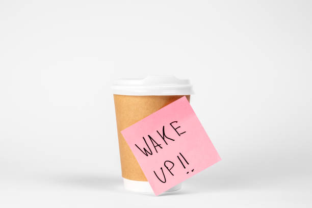 istock Disposable paper cup with a reminder paper on a white background isolated. 1488417675