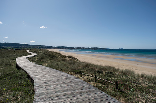 Wooden walkway on the dunes of A Lanzada Beach in Galicia, Spain