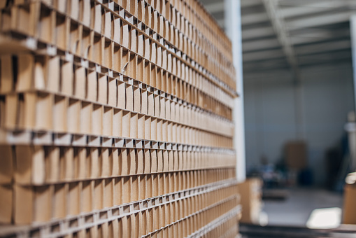 Distribution cardboard factory warehouse with cardboard stacks.