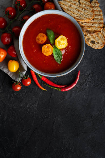 istock Gazpacho soup with tomato and ingredients on black background 1488420970