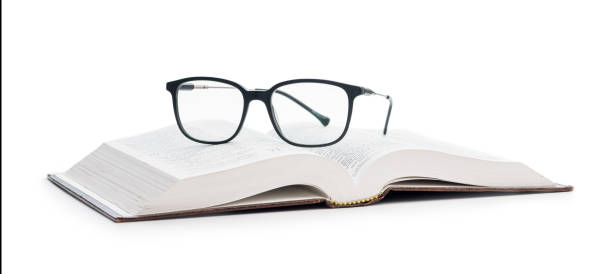 istock The reading glasses on opened book isolated on white background. 1488421420
