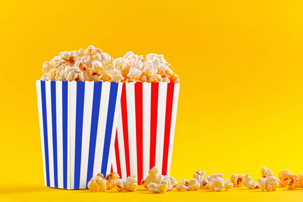 istock Glass with popcorn on a yellow background 1488422884