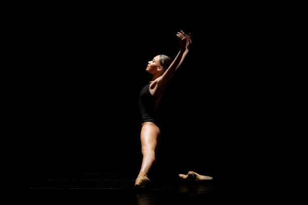 istock Young girl dancing Neo Classic Ballet on dark stage 1488423498
