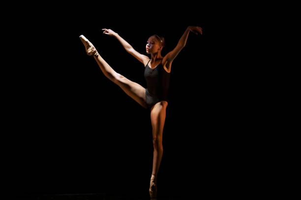 istock Young girl dancing Neo Classic Ballet on dark stage 1488423503