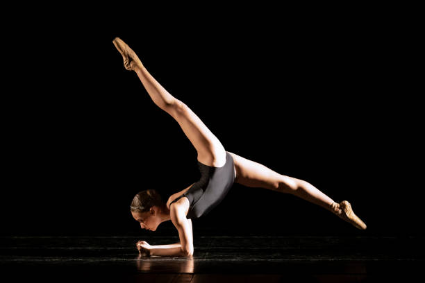 istock Young girl dancing Neo Classic Ballet on dark stage 1488423529