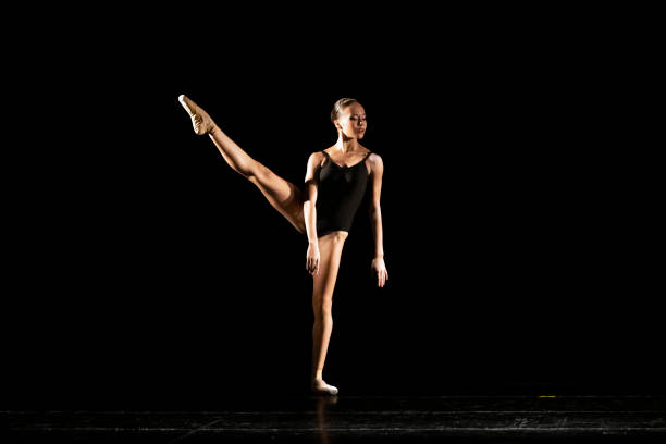 istock Young girl dancing Neo Classic Ballet on dark stage 1488423539