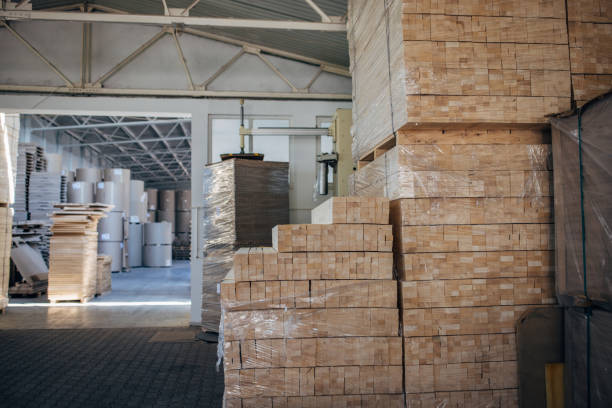 istock Cardboard stacks in factory warehouse 1488425047