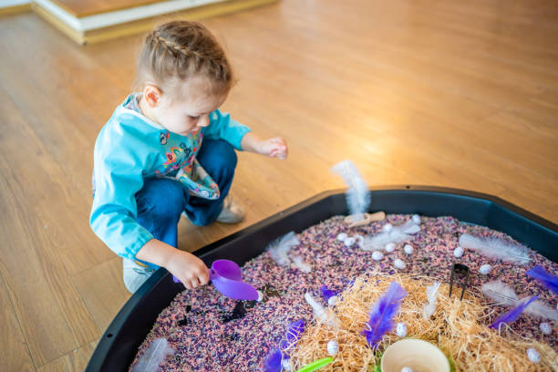 istock Little girl playing with sensory colorful rice. Sensory development and experiences, themed activities with children, fine motor skills development 1488426331
