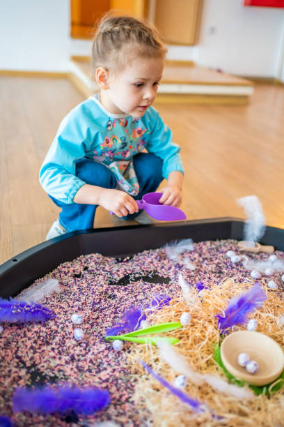 istock Little girl playing with sensory colorful rice. Sensory development and experiences, themed activities with children, fine motor skills development 1488426344