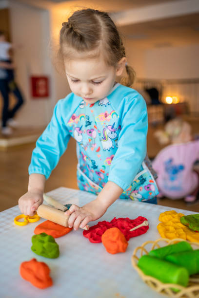 istock A little girl playing with plasticine. Sensory development and experiences, themed activities with children, fine motor skills development 1488426349