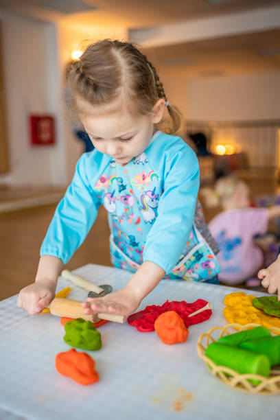 istock A little girl playing with plasticine. Sensory development and experiences, themed activities with children, fine motor skills development 1488426350