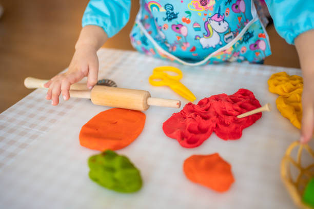 istock A little girl playing with plasticine. Sensory development and experiences, themed activities with children, fine motor skills development 1488426351