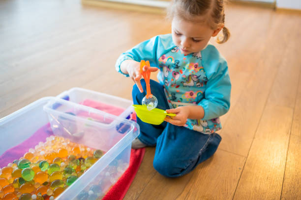istock Little girl playing with sensory water beads, hydrogel balls. Sensory development and experiences, themed activities with children, fine motor skills development 1488426358