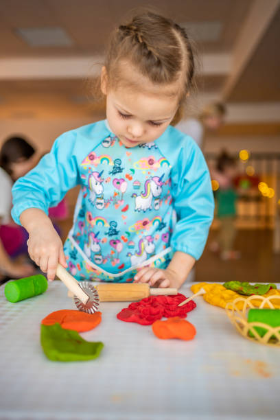 istock A little girl playing with plasticine. Sensory development and experiences, themed activities with children, fine motor skills development 1488426405