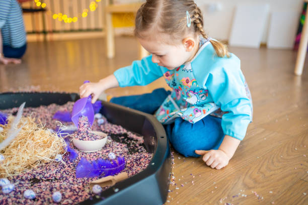 istock Little girl playing with sensory colorful rice. Sensory development and experiences, themed activities with children, fine motor skills development 1488426409