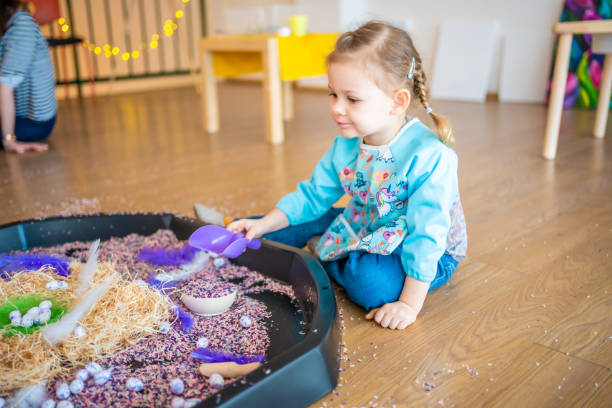 istock Little girl playing with sensory colorful rice. Sensory development and experiences, themed activities with children, fine motor skills development 1488426410