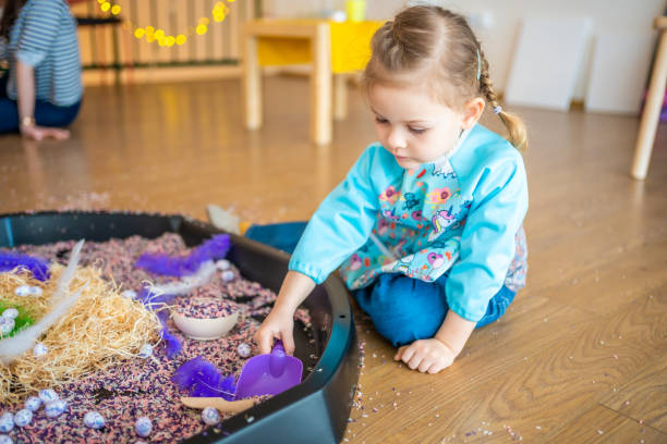 istock Little girl playing with sensory colorful rice. Sensory development and experiences, themed activities with children, fine motor skills development 1488426411