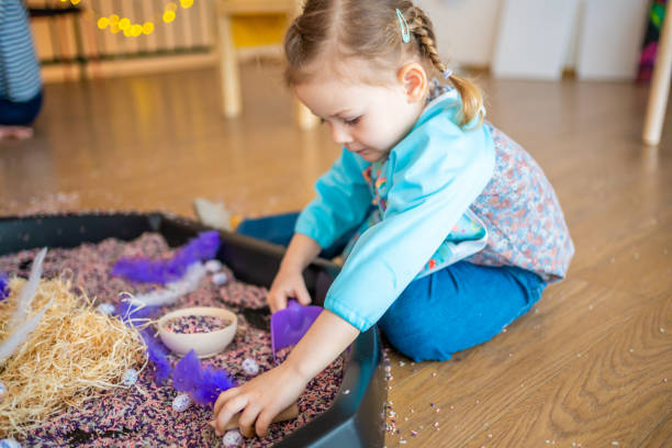 istock Little girl playing with sensory colorful rice. Sensory development and experiences, themed activities with children, fine motor skills development 1488426420