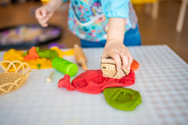 istock A little girl playing with plasticine. Sensory development and experiences, themed activities with children, fine motor skills development 1488426424