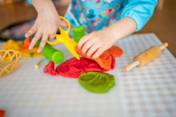 istock A little girl playing with plasticine. Sensory development and experiences, themed activities with children, fine motor skills development 1488426437
