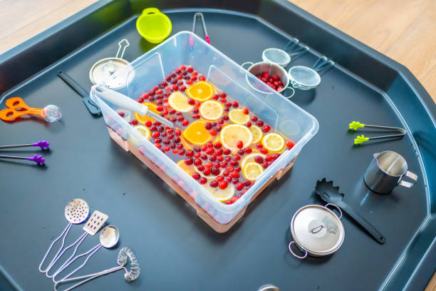 istock Homemade fruit bar with kitchenware, berries and citrus fruits. Sensory development and experiences, themed activities with children, fine motor skills development 1488427727