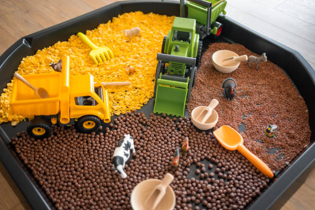 Sensory flakes like a sandbox for playing. Sensory development and experiences, themed activities with children, fine motor skills development