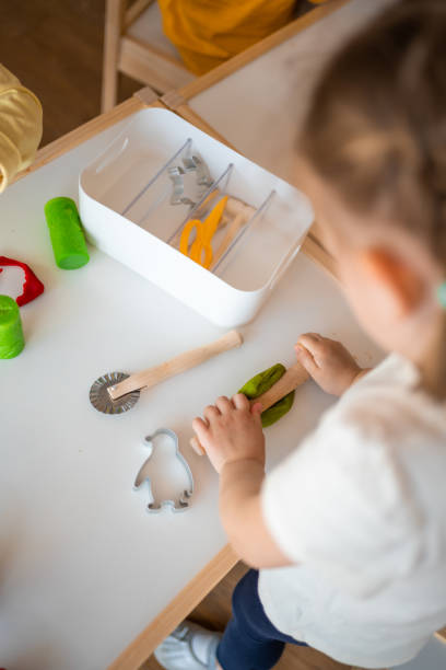 istock A little girl playing with plasticine. Sensory development and experiences, themed activities with children, fine motor skills development 1488427901
