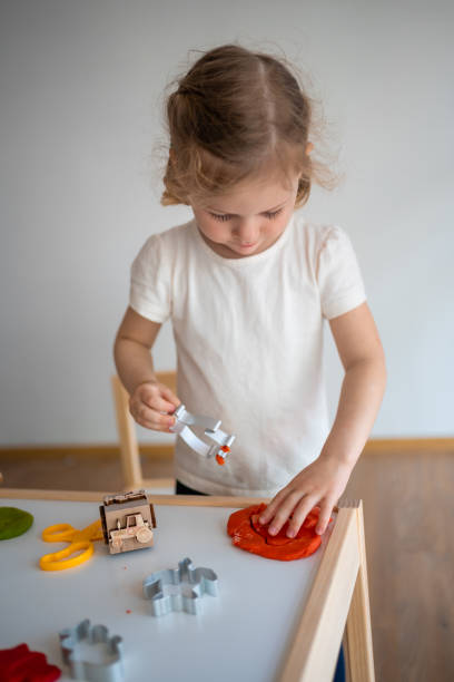 istock A little girl playing with plasticine. Sensory development and experiences, themed activities with children, fine motor skills development 1488427913