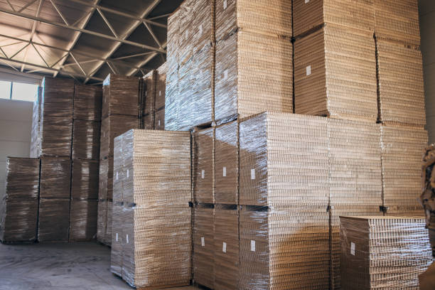 istock Cardboard stacks in factory warehouse 1488429939