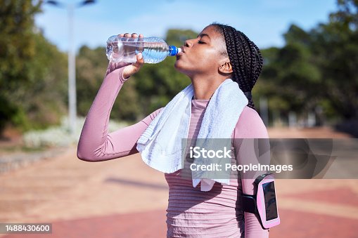 istock Fitness, black woman and drinking water for hydration, training and exercise for wellness, healthy lifestyle and workout. African female athlete, lady and runner with bottle, aqua and liquid for rest 1488430600