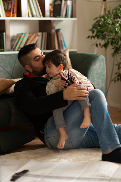 istock Father and boy working together at home 1488432341