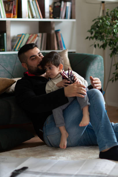 istock Father and boy working together at home 1488432483