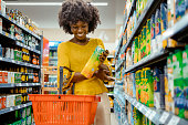 Woman With Food Basket at Grocery Store