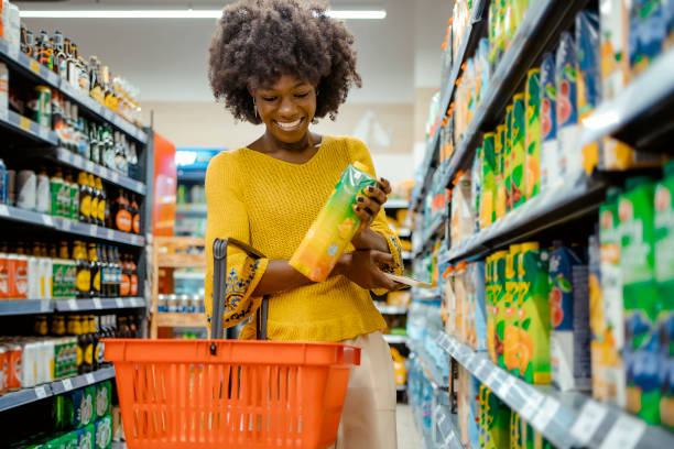 Woman With Food Basket at Grocery Store stock photo