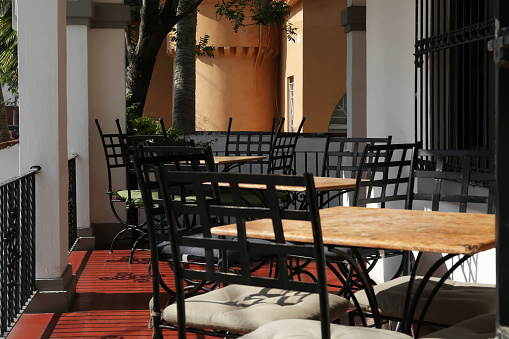 Chairs at tables on terrace near cafe