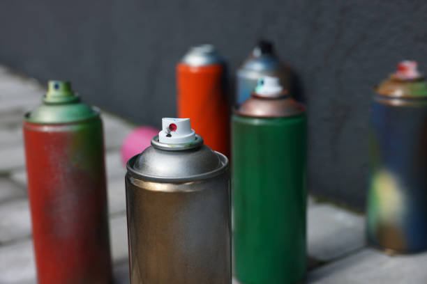 istock Cans of different spray paints near wall outdoors, closeup 1488432892