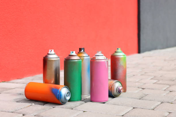 istock Cans of different spray paints on pavement near wall 1488432908