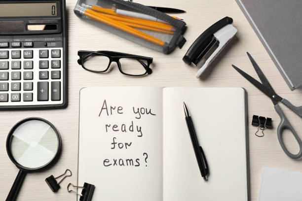 istock Notebook with question Are You Ready For Exams? on white wooden table, flat lay 1488432987